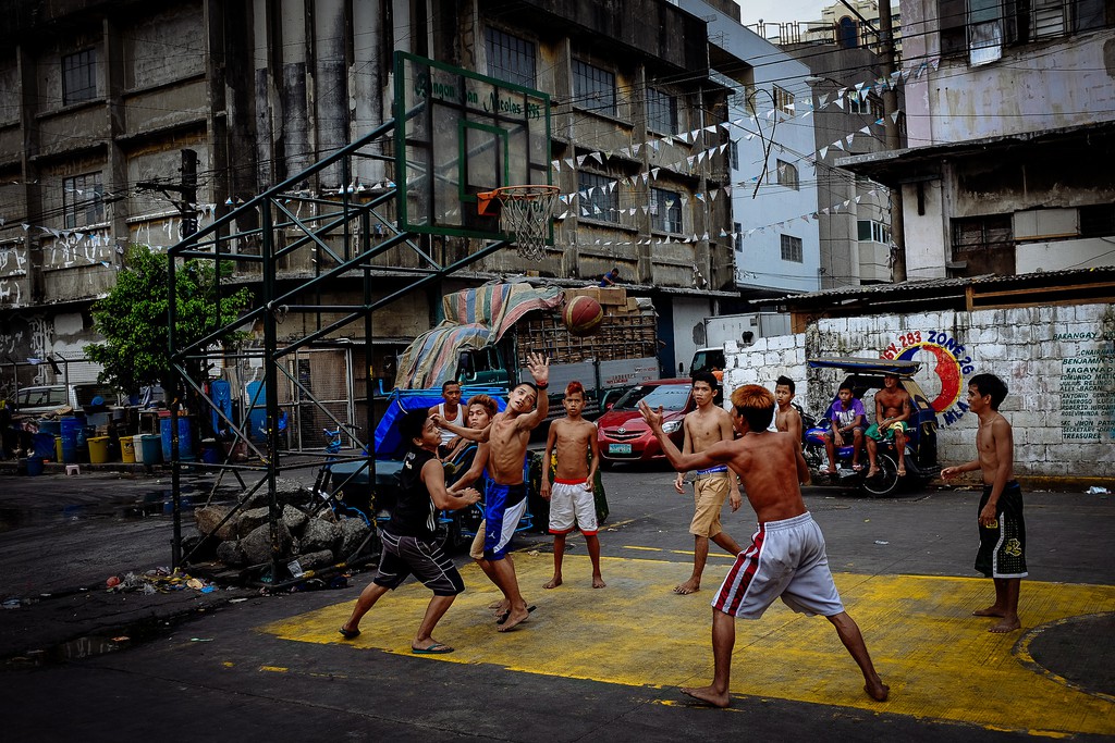 Players on an outdoor basketball court in the Philippines